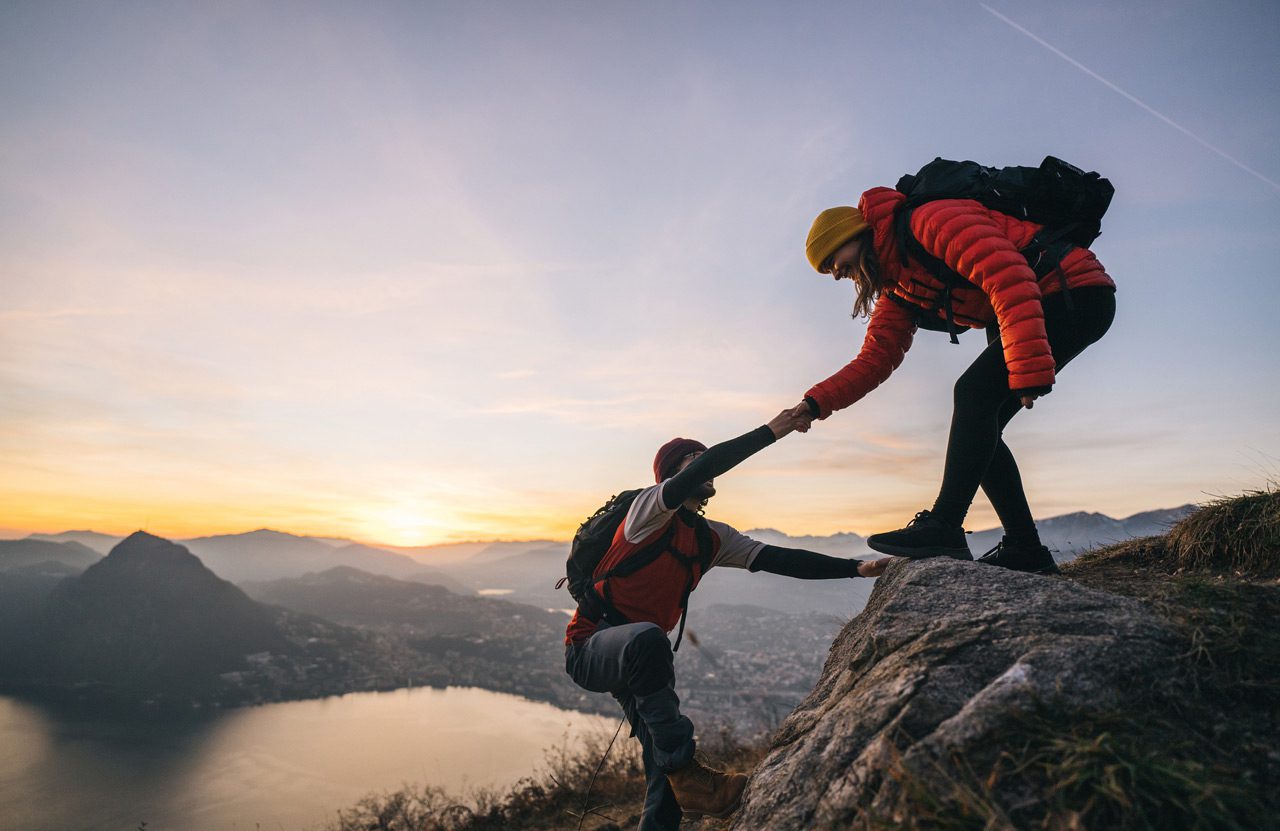 Hiking-couple-climbing-up-mountain-ridge-1