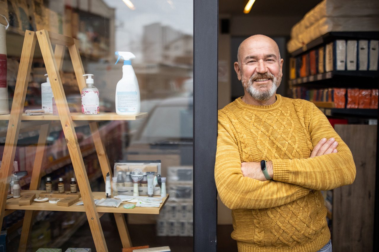 Proud-owner-standing-with-arms-crossed-in-front-of-his-store