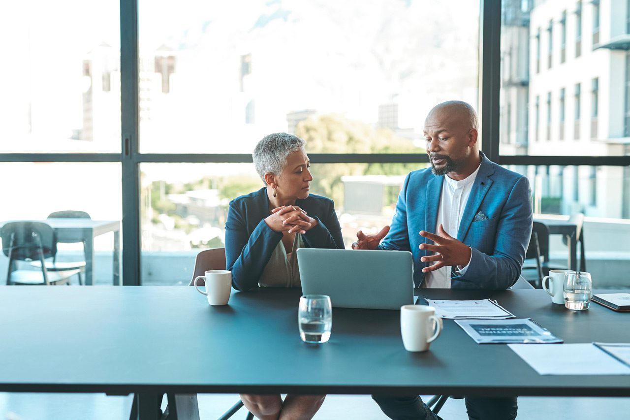 image-of-two-salespeople-seated-at-a-table