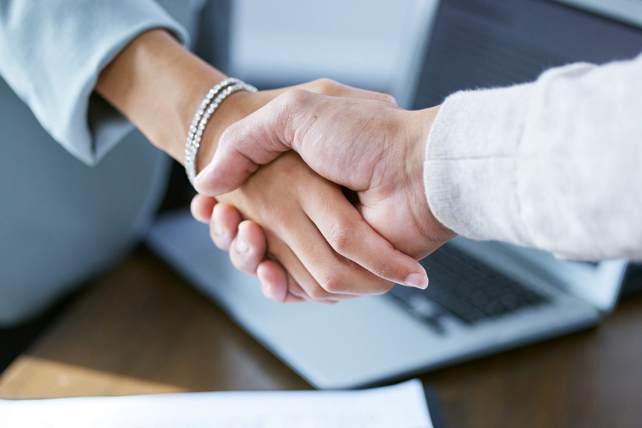 two-businesspeople-shaking-hands